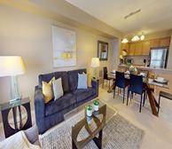 Garden Villas - Short-term rental in Mississauga furnished living room open to dining area and fully-equipped kitchen - Premiere Suites