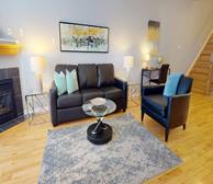 Pineview - Ottawa fully furnished townhouse living room with black leather couch and tv - Premiere Suites