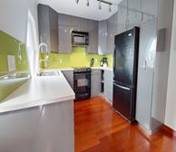 57 Harvey Road - St. John's fully furnished apartment suite kitchen with grey cabinets and lime green backsplash - Premiere Suites