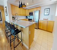 Bishops Landing 1475 - Halifax corporate housing kitchen with wood cabinets and black barstools - Premiere Suites