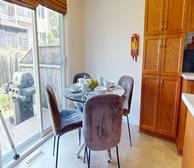 Beacon Hill South II - Ottawa furnished short-term rental dining room with glass table and grey suede chairs - Premiere Suites