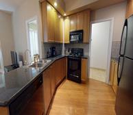 Circa 1 - Markham fully furnished apartment rental fully equipped kitchen with black appliances - Premiere Suites