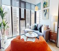 The Emmy - Spacious living room with city views in a corporate housing suite in Ottawa - Premiere Suites