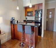 Signal Hill Gate - St. John's short-term rental kitchen with dark brown cabinets and black countertops - Premiere Suites