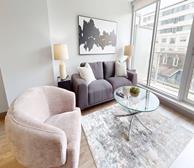 Star of the Sea - St. John's short-term rental apartment furnished living room with grey couch and large windows - Premiere Suites