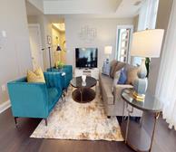 The Avery - Fully furnished apartment in Dartmouth living space with brown couch and blue armchairs - Book your Premiere Suites stay