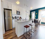 120 Nadia Drive - Dartmouth fully furnished apartment kitchen with white cabinets and brown barstools - Premiere Suites