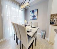 Balinroan Crescent - Furnished townhouse rental in Ottawa dining room with white dining table and grey chairs - Premiere Suites