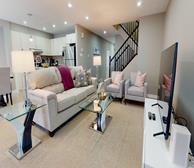 Balinroan Crescent - Spacious and bright Ottawa townhouse with white couch and glass coffee table - Premiere Suites