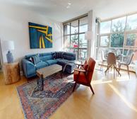 Bishops Landing LW79 - Halifax monthly rental furnished living room with grey couch and fireplace - Premiere Suites