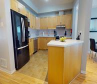 Pineview - Fully furnished townhouse in Ottawa kitchen with light wood cabinets and stainless steel appliances - Premiere Suites