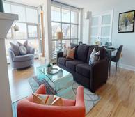 Bishops Landing 1475 - Halifax serviced apartments living room with blue couch and black coffee table - Premiere Suites