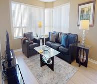 Skymark - Mississauga short-term rental apartment spacious living room and dining room with large windows - Premiere Suites