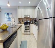 Balinroan Crescent - Ottawa fully furnished townhouse kitchen with white cabinets and stainless steel appliances - Premiere Suites