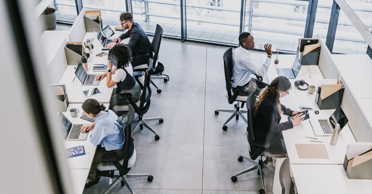 Employees working at their desks in a corporate office