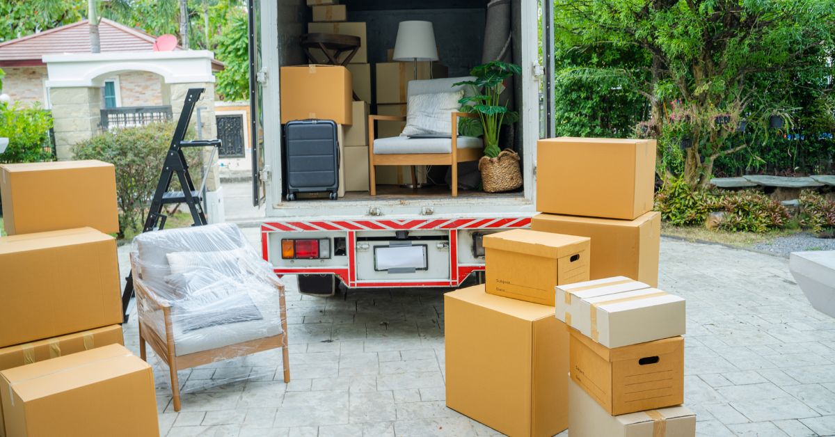 Moving truck parked filled with packed boxes