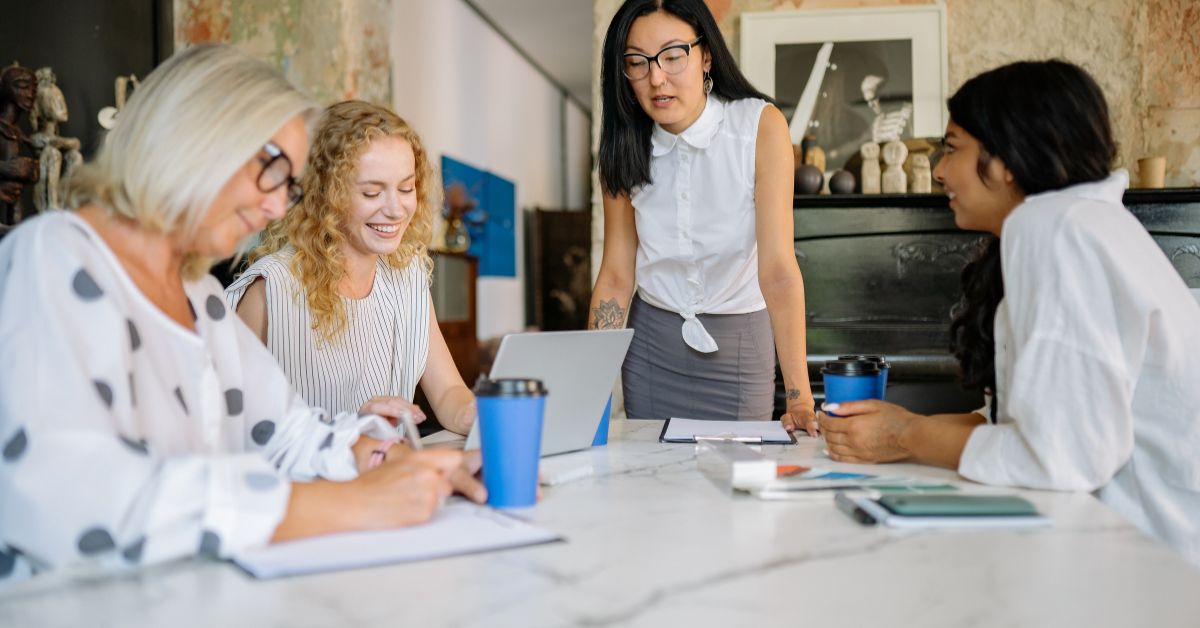 Women gathered around a desk having a meeting